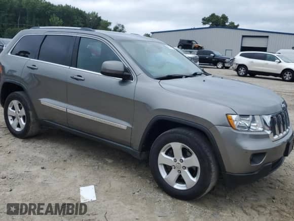 2012 Jeep Grand Cherokee Laredo z VIN 1C4RJEAG4CC261079, wystawiony jako Copart lot #69724335 z przebiegiem 156 712 mil mil oraz Szkoda całkowita • Salvage title. Historia ofert i sprzedaży dostępna na DreamBid. Obrazek 4.