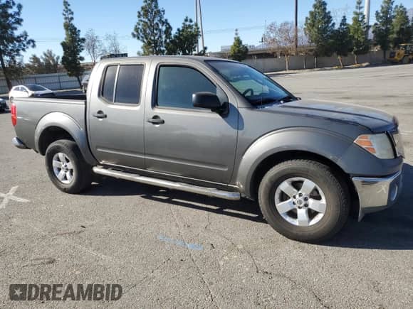 2009 Nissan Frontier SE with VIN 1N6AD07U49C405420, listed as a Copart auction lot 41983545 with 203,700 mi miles and Salvage title. Bid and sale history available at DreamBid. Image 4.