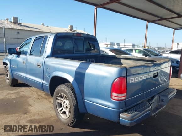 2002 Dodge Dakota Sport with VIN 1B7HL38N22S652119, listed as a IAAI auction lot 43395458 with 162,733 mi miles and . Bid and sale history available at DreamBid. Image 3.