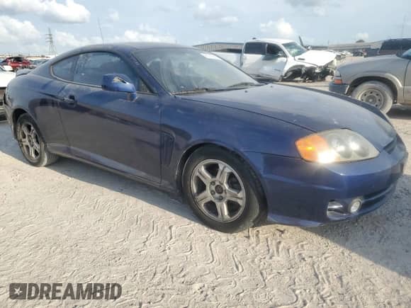 2003 Hyundai Tiburon с VIN KMHHM65D03U095741, выставлен на аукционе Copart как лот 55147305 с пробегом 170 946 миль миль и Списание • Salvage title. История ставок и продаж доступна на DreamBid. Изображение 4.