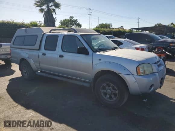 2004 Nissan Frontier XE with VIN 1N6ED29X24C429616, listed as a Copart auction lot 57605075 with 214,815 mi miles and Salvage title. Bid and sale history available at DreamBid. Image 4.