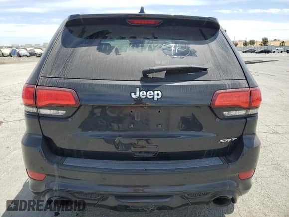 2014 Jeep Grand Cherokee SRT-8 z VIN 1C4RJFDJXEC379766, wystawiony jako Copart lot #63656015 z przebiegiem Nie podano mil oraz Szkoda całkowita • Salvage title. Historia ofert i sprzedaży dostępna na DreamBid. Obrazek 6.