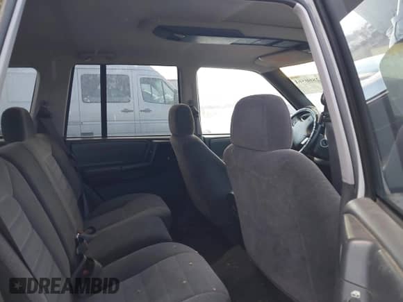 1996 Jeep Grand Cherokee Laredo z VIN 1J4GZ58S9TC245352, wystawiony jako IAAI lot #42860561 z przebiegiem Nie podano mil oraz . Historia ofert i sprzedaży dostępna na DreamBid. Obrazek 8.