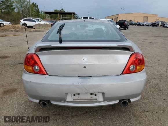 2003 Hyundai Tiburon GT с VIN KMHHN65F13U013420, выставлен на аукционе Copart как лот 51234495 с пробегом 230 612 миль миль и Списание • Salvage title. История ставок и продаж доступна на DreamBid. Изображение 6.