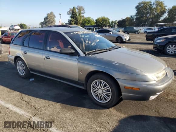 1997 Saturn SW with VIN 1G8ZK8279VZ169005, listed as a Copart auction lot 73049694 with 110,215 mi miles and Salvage title. Bid and sale history available at DreamBid. Image 4.