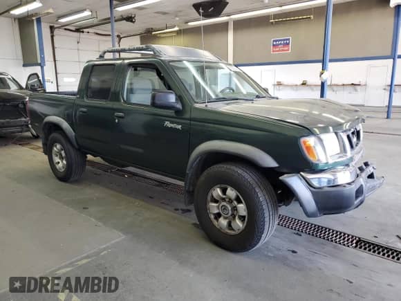 2000 Nissan Frontier XE with VIN 1N6ED27YXYC397550, listed as a Copart auction lot 59397465 with 119,247 mi miles and Salvage title. Bid and sale history available at DreamBid. Image 4.