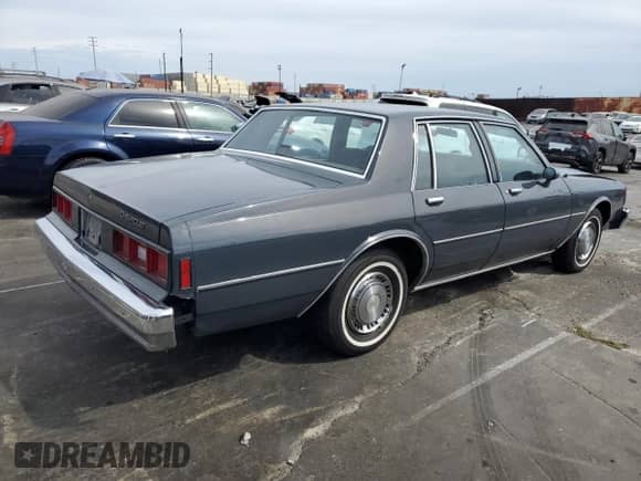 1984 Chevrolet Impala z VIN 1G1AL69H5EX151138, wystawiony jako Copart lot #81291035 z przebiegiem 21 974 mil mil oraz Szkoda całkowita • Salvage title. Historia ofert i sprzedaży dostępna na DreamBid. Obrazek 3.