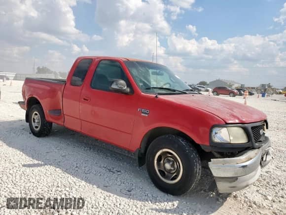 2000 Ford F-150 XL with VIN 1FTRX07WXYKB39193, listed as a Copart auction lot 85164785 with 296,921 mi miles and Salvage title. Bid and sale history available at DreamBid. Image 4.