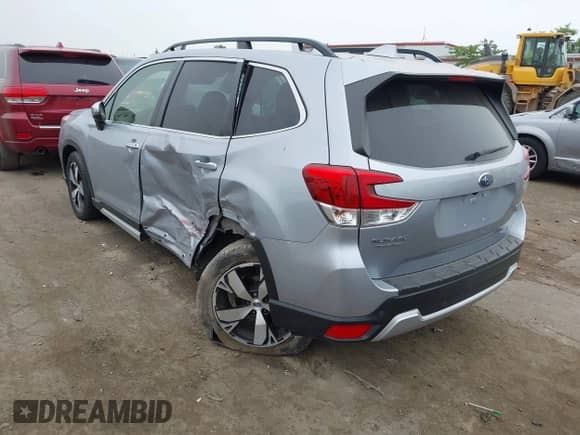 2020 Subaru Forester Touring with VIN JF2SKAXCXLH494092, listed as a IAAI auction lot 42504297 with 83,051 mi miles and . Bid and sale history available at DreamBid. Image 3.