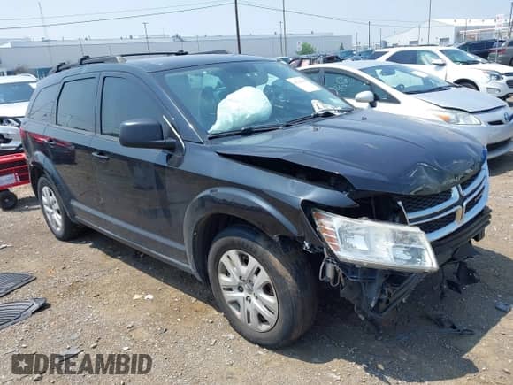 2013 Dodge Journey American Value z VIN 3C4PDCAB2DT671764, wystawiony jako IAAI lot #42745438 z przebiegiem 178 599 mil mil oraz . Historia ofert i sprzedaży dostępna na DreamBid. Obrazek 1.