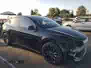 2022 Tesla Model Y Performance with VIN 7SAYGDEF9NF393852, listed as a Copart auction lot 63141094 with 26,972 mi miles and Salvage title. Bid and sale history available at DreamBid. Image 4.