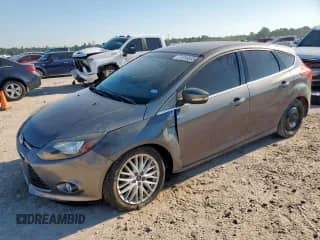 2013 Ford Focus Titanium with VIN 1FADP3N2XDL334085, listed as a Copart auction lot 71316535 with 127,093 mi miles and Salvage title. Bid and sale history available at DreamBid. Image 1.