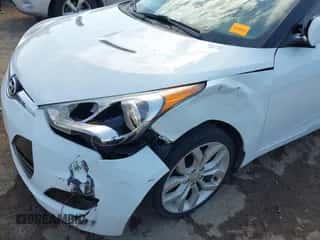 2012 Hyundai Veloster w/Black Int z VIN KMHTC6AD0CU023702, wystawiony jako IAAI lot #43149525 z przebiegiem 166 308 mil mil oraz . Historia ofert i sprzedaży dostępna na DreamBid. Obrazek 6.