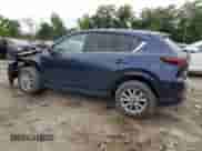 2024 Mazda CX-5 S Select z VIN JM3KFBBM5R0383781, wystawiony jako Copart lot #69091465 z przebiegiem 4 963 mil mil oraz Szkoda całkowita • Salvage title. Historia ofert i sprzedaży dostępna na DreamBid. Obrazek 2.