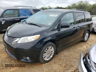 2012 Toyota Sienna XLE with VIN 5TDYK3DC6CS278292, listed as a Copart auction lot 52770125 with 219,699 mi miles and Salvage title. Bid and sale history available at DreamBid. Image 1.