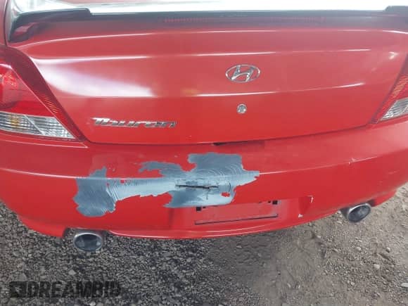 2005 Hyundai Tiburon GS z VIN KMHHM65DX5U156547, wystawiony jako IAAI lot #41786434 z przebiegiem 135 532 mil mil oraz . Historia ofert i sprzedaży dostępna na DreamBid. Obrazek 6.