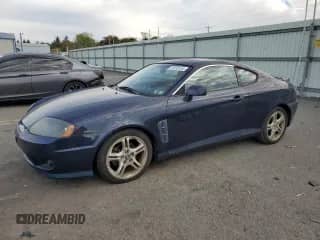 2005 Hyundai Tiburon GT с VIN KMHHN65F95U159244, выставлен на аукционе Copart как лот 76318134 с пробегом 78 324 миль миль и Чистый • Clean title. История ставок и продаж доступна на DreamBid. Изображение 1.