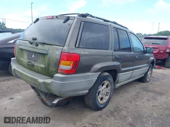 1999 Jeep Grand Cherokee Laredo z VIN 1J4GW58NXXC736618, wystawiony jako IAAI lot #43042986 z przebiegiem Nie podano mil oraz . Historia ofert i sprzedaży dostępna na DreamBid. Obrazek 4.
