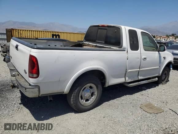 1999 Ford F-150 with VIN 1FTRX18W7XKA55819, listed as a Copart auction lot 64293245 with 301,658 mi miles and Salvage title. Bid and sale history available at DreamBid. Image 3.