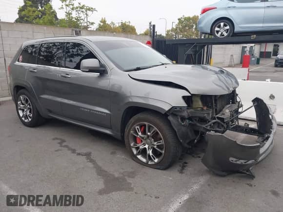 2012 Jeep Grand Cherokee SRT-8 z VIN 1C4RJFDJ8CC112350, wystawiony jako IAAI lot #42995991 z przebiegiem 210 738 mil mil oraz . Historia ofert i sprzedaży dostępna na DreamBid. Obrazek 1.