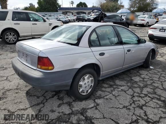 1996 Saturn SL z VIN 1G8ZH5288TZ156412, wystawiony jako Copart lot #44429465 z przebiegiem 141 560 mil mil oraz Szkoda całkowita • Salvage title. Historia ofert i sprzedaży dostępna na DreamBid. Obrazek 3.
