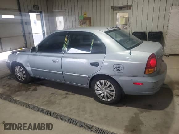 2005 Hyundai Accent GLS z VIN KMHCG45C65U662633, wystawiony jako Copart lot #86432595 z przebiegiem 221 608 mil mil oraz Szkoda całkowita • Salvage title. Historia ofert i sprzedaży dostępna na DreamBid. Obrazek 2.