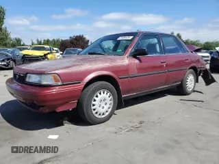 1991 Toyota Camry DLX z VIN 4T1SV21E7MU414824, wystawiony jako Copart lot #61604434 z przebiegiem 170 867 mil mil oraz Szkoda całkowita • Salvage title. Historia ofert i sprzedaży dostępna na DreamBid. Obrazek 1.