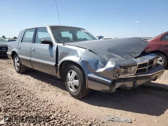1991 Dodge Dynasty LE with VIN 1B3XC56R9MD115785, listed as a Copart auction lot 48073715 with 64,483 mi miles and Salvage title. Bid and sale history available at DreamBid. Image 4.