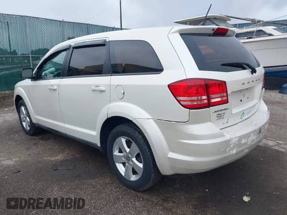 2013 Dodge Journey American Value z VIN 3C4PDCAB2DT576623, wystawiony jako IAAI lot #43018876 z przebiegiem 119 698 mil mil oraz . Historia ofert i sprzedaży dostępna na DreamBid. Obrazek 3.