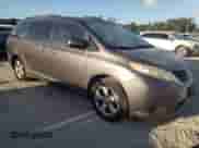 2012 Toyota Sienna LE with VIN 5TDKK3DC5CS231390, listed as a Copart auction lot 85662385 with 125,918 mi miles and Salvage title. Bid and sale history available at DreamBid. Image 4.