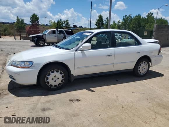 2002 Honda Accord LX with VIN JHMCG56482C030489, listed as a Copart auction lot 66217045 with 124,672 mi miles and Salvage title. Bid and sale history available at DreamBid. Image 1.