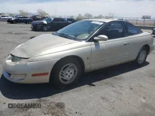 1997 Saturn SC with VIN 1G8ZG1277VZ308296, listed as a Copart auction lot 59011285 with 250,576 mi miles and Salvage title. Bid and sale history available at DreamBid. Image 1.