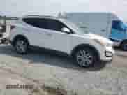 2014 Hyundai Santa Fe with VIN 5XYZUDLA2EG202069, listed as a Copart auction lot 70583405 with 190,694 mi miles and Salvage title. Bid and sale history available at DreamBid. Image 4.