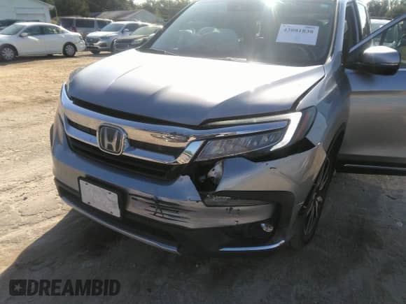 2021 Honda Pilot Touring 7-Passenger with VIN 5FNYF5H69MB000710, listed as a IAAI auction lot 43081838 with 91,899 mi miles and . Bid and sale history available at DreamBid. Image 6.
