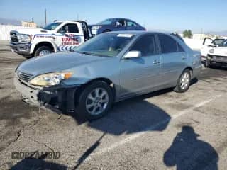 2005 Toyota Camry LE with VIN JTDBF30KX50160730, listed as a Copart auction lot 84997435 with 238,964 mi miles and Salvage title. Bid and sale history available at DreamBid. Image 1.