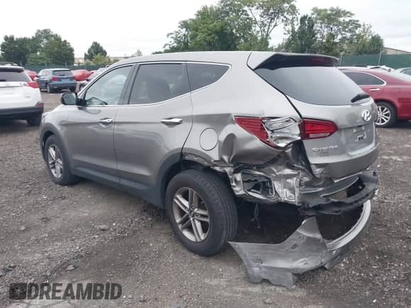 2018 Hyundai Santa Fe 2.4L z VIN 5XYZTDLB4JG526856, wystawiony jako IAAI lot #42998185 z przebiegiem 106 919 mil mil oraz . Historia ofert i sprzedaży dostępna na DreamBid. Obrazek 3.