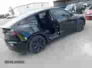 2024 Tesla Model Y with VIN 7SAYGDED8RF156984, listed as a IAAI auction lot 43324819 with 26,941 mi miles and . Bid and sale history available at DreamBid. Image 4.