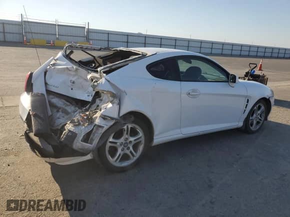 2006 Hyundai Tiburon GT z VIN KMHHN65F46U191990, wystawiony jako Copart lot #61887894 z przebiegiem 252 384 mil mil oraz Szkoda całkowita • Salvage title. Historia ofert i sprzedaży dostępna na DreamBid. Obrazek 3.