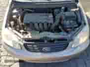 2004 Toyota Corolla CE z VIN 1NXBR32E94Z301126, wystawiony jako Copart lot #87467835 z przebiegiem 181 189 mil mil oraz Szkoda całkowita • Salvage title. Historia ofert i sprzedaży dostępna na DreamBid. Obrazek 11.