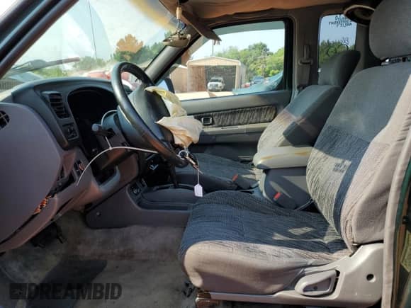 2000 Nissan Frontier XE with VIN 1N6ED26TXYC332543, listed as a Copart auction lot 64014015 with 186,261 mi miles and Salvage title. Bid and sale history available at DreamBid. Image 7.