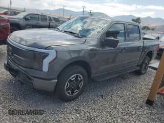 2023 Ford F-150 Lightning Pro with VIN 1FTVW1EL7PWG58631, listed as a Copart auction lot 62957695 with 13,200 mi miles and Salvage title. Bid and sale history available at DreamBid. Image 1.