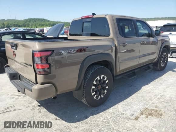 2023 Nissan Frontier Pro-4X with VIN 1N6ED1EK0PN668109, listed as a Copart auction lot 57064975 with 6,406 mi miles and Salvage title. Bid and sale history available at DreamBid. Image 3.