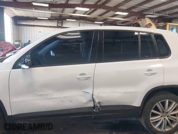 2013 Volkswagen Tiguan with VIN WVGCV3AX7DW605594, listed as a IAAI auction lot 42057457 with 131,629 mi miles and . Bid and sale history available at DreamBid. Image 14.