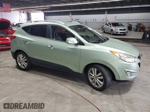 2011 Hyundai Tucson GLS with VIN KM8JU3ACXBU225908, listed as a Copart auction lot 71079005 with 114,646 mi miles and Salvage title. Bid and sale history available at DreamBid. Image 4.
