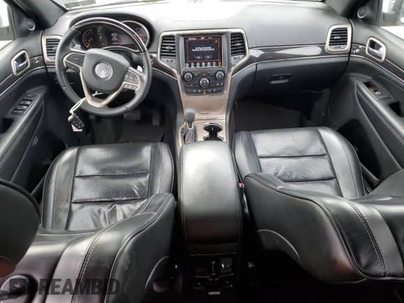 2016 Jeep Grand Cherokee Overland with VIN 1C4RJFCG6GC489769, listed as a Copart auction lot 82302855 with 136,225 mi miles and Salvage title. Bid and sale history available at DreamBid. Image 8.