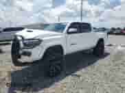 2018 Toyota Tacoma SR with VIN 5TFCZ5ANXJX162902, listed as a Copart auction lot 68464895 with 105,750 mi miles and Salvage title. Bid and sale history available at DreamBid. Image 1.