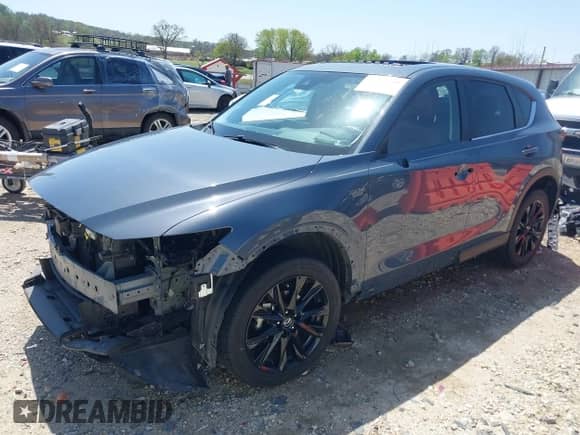 2022 Mazda CX-5 S Carbon Edition z VIN JM3KFBCM7N1543338, wystawiony jako IAAI lot #41994700 z przebiegiem 67 855 mil mil oraz . Historia ofert i sprzedaży dostępna na DreamBid. Obrazek 2.