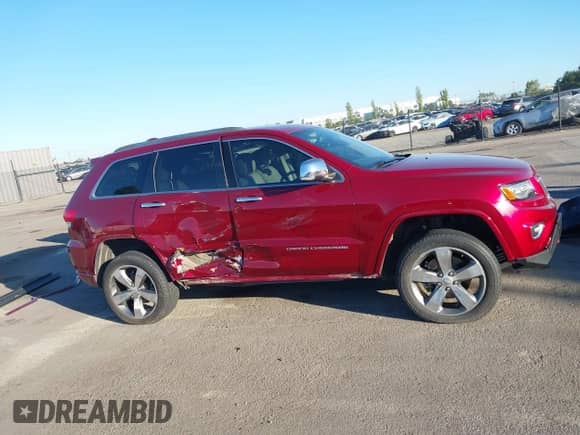 2015 Jeep Grand Cherokee Overland z VIN 1C4RJFCG6FC613232, wystawiony jako IAAI lot #43476794 z przebiegiem 106 697 mil mil oraz . Historia ofert i sprzedaży dostępna na DreamBid. Obrazek 14.