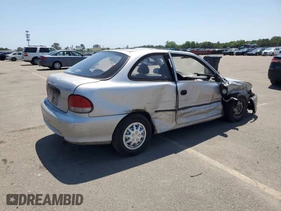 1999 Hyundai Accent L z VIN KMHVD14N9XU497814, wystawiony jako Copart lot #60374665 z przebiegiem 287 585 mil mil oraz Szkoda całkowita • Salvage title. Historia ofert i sprzedaży dostępna na DreamBid. Obrazek 3.