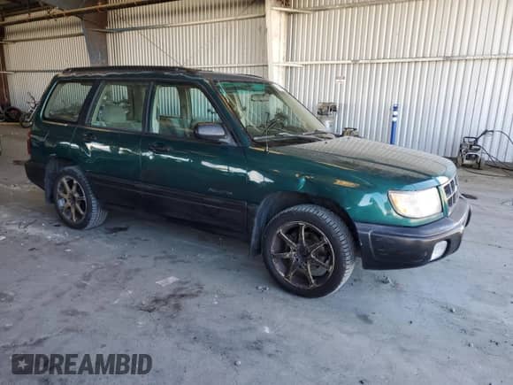 1999 Subaru Forester L with VIN JF1SF6355XG717440, listed as a Copart auction lot 65808265 with 374,544 mi miles and Salvage title. Bid and sale history available at DreamBid. Image 4.